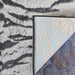 Corner of Couristan Dolce Indoor/Outdoor Rug - Bengal/Ivory flipped over showing the tightly woven backing and front tiger-stripe pattern