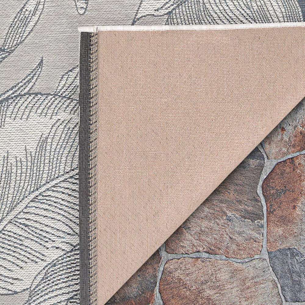 Corner of Couristan Dolce Indoor/Outdoor Rug - Flora/Argento shows its stitched edge and backing folded over