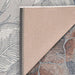 Corner of Couristan Dolce Indoor/Outdoor Rug - Flora/Argento shows its stitched edge and backing folded over