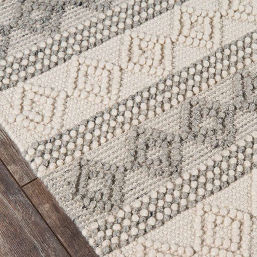 Corner of Momeni Andes Indoor Rug - AND-10 Ivory highlights its soft wool texture and detailed design
