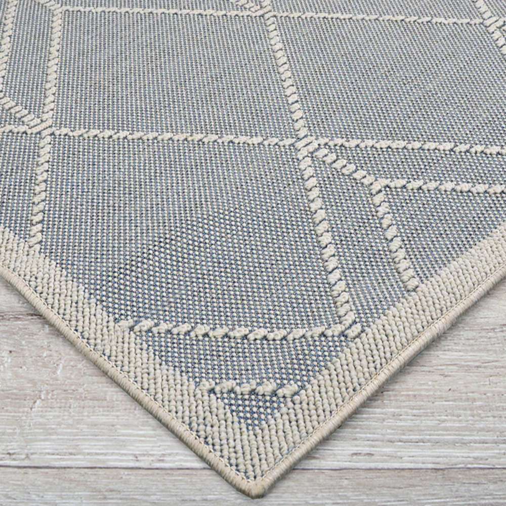 Corner view of Couristan Liguria Indoor/Outdoor Rug - Noli/Azul highlights its tightly woven texture and ivory border
