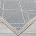 Corner view of Couristan Liguria Indoor/Outdoor Rug - Noli/Azul highlights its tightly woven texture and ivory border
