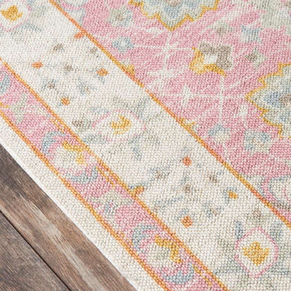 Corner view of Momeni Anatolia Indoor Rug - ANA-8 Pink shows its cream border with pastel floral accents