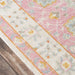 Corner view of Momeni Anatolia Indoor Rug - ANA-8 Pink shows its cream border with pastel floral accents