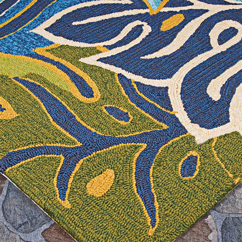 Corner detail of the Couristan Covington Indoor/Outdoor Rug - Areca Palms/Brown-Forest Green highlights the contrast between the bright yellow, blue, and fern green lines