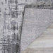 Corner of the Couristan Charm Indoor/Outdoor Rug - Tiverton/Anthracite-Light Grey is flipped to show its underside and weave construction