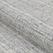 Couristan Ascot Indoor/Outdoor Rug - Windowpane/Grey is shown in a rolled-up view to highlight its soft, looped texture and subtle pattern