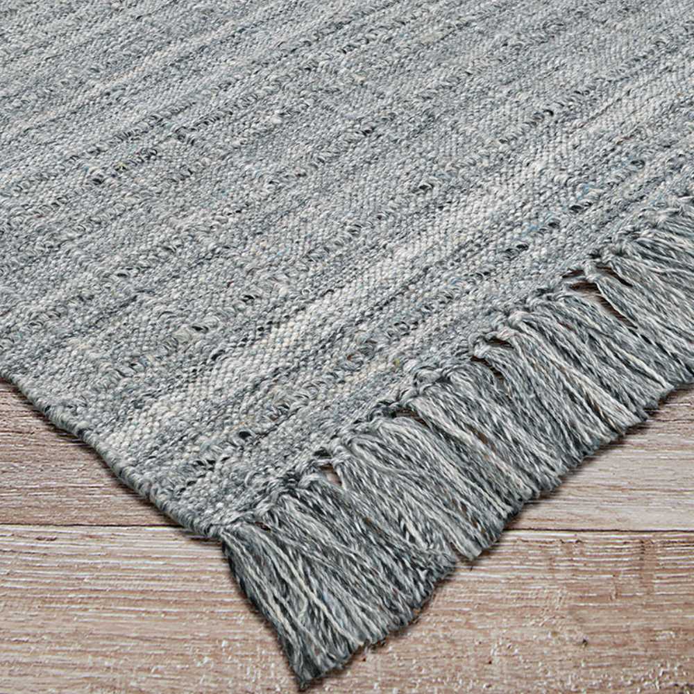 Couristan Ascot Indoor/Outdoor Rug - Windowpane/Tweed is shown at an angle, emphasizing its strong weave and tidy corner fringe