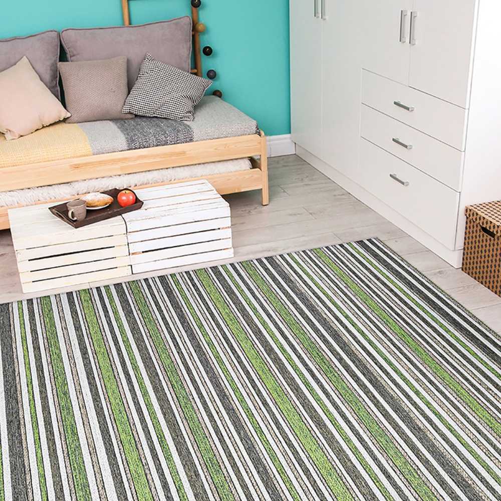 Couristan Cape Indoor/Outdoor Rug - Brockton/Hunter Green-Brown lies on a light wood floor in a cozy bedroom with a daybed and white cabinet