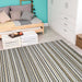 Couristan Cape Indoor/Outdoor Rug - Brockton/Light Brown-Ivory in a cozy bedroom with a daybed and white furniture