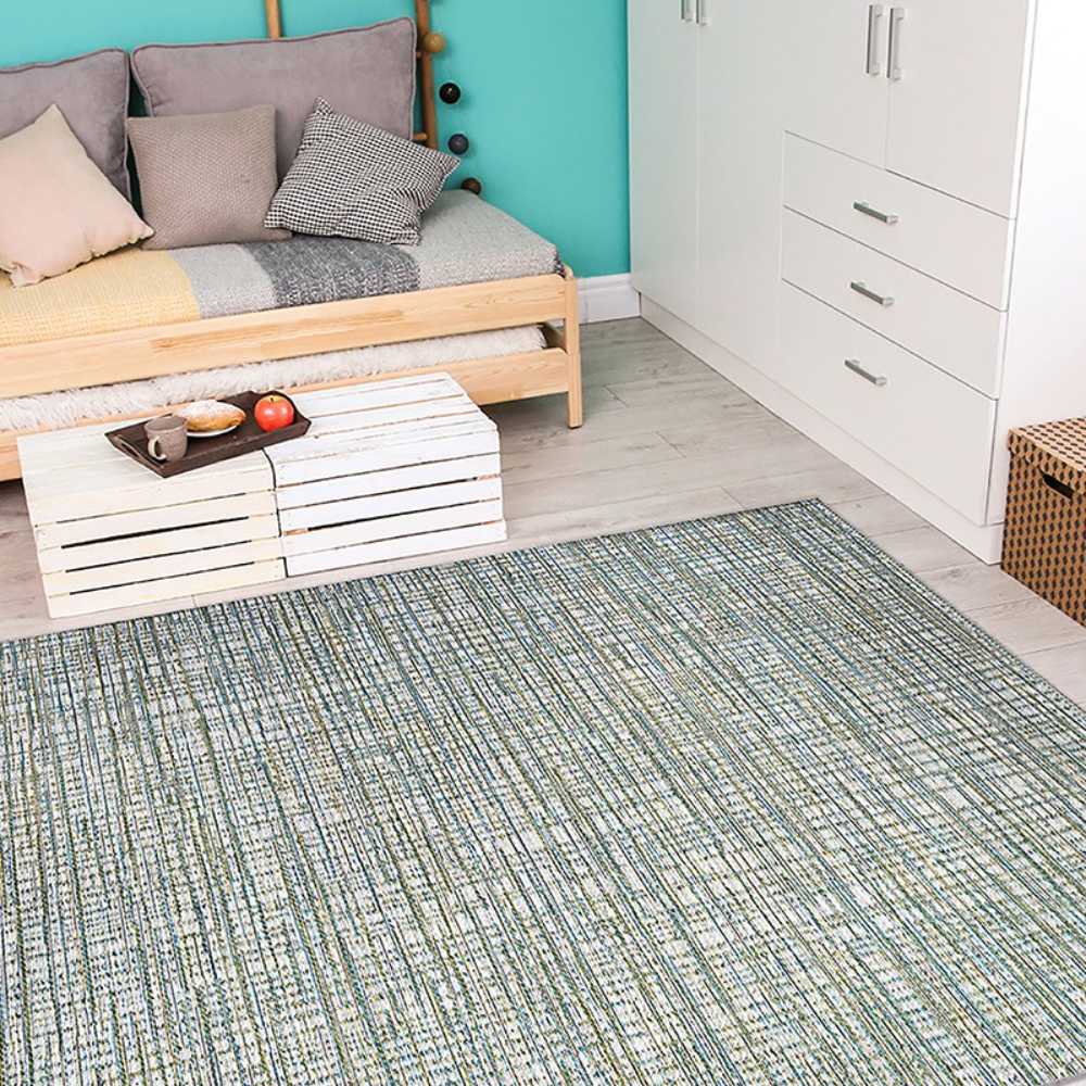 Couristan Cape Indoor/Outdoor Rug - Falmouth/Ivory-Hunter is shown in a cozy bedroom