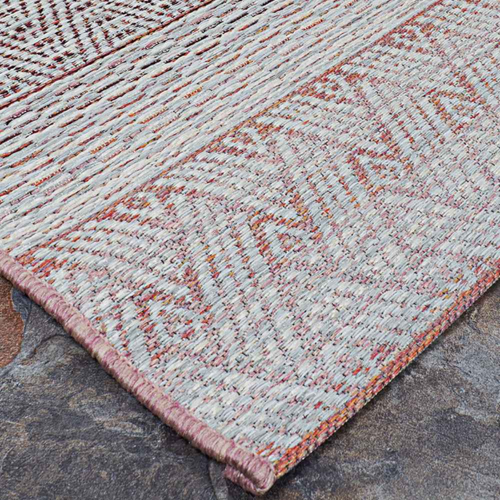 Couristan Cape Indoor/Outdoor Rug - Gables/Hibiscus lies flat on a stone floor