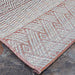 Couristan Cape Indoor/Outdoor Rug - Gables/Hibiscus lies flat on a stone floor