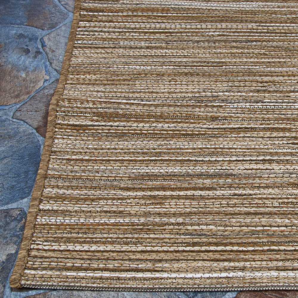 Couristan Cape Indoor/Outdoor Rug - Hinsdale/Brown-Ivory is laid out on a stone patio