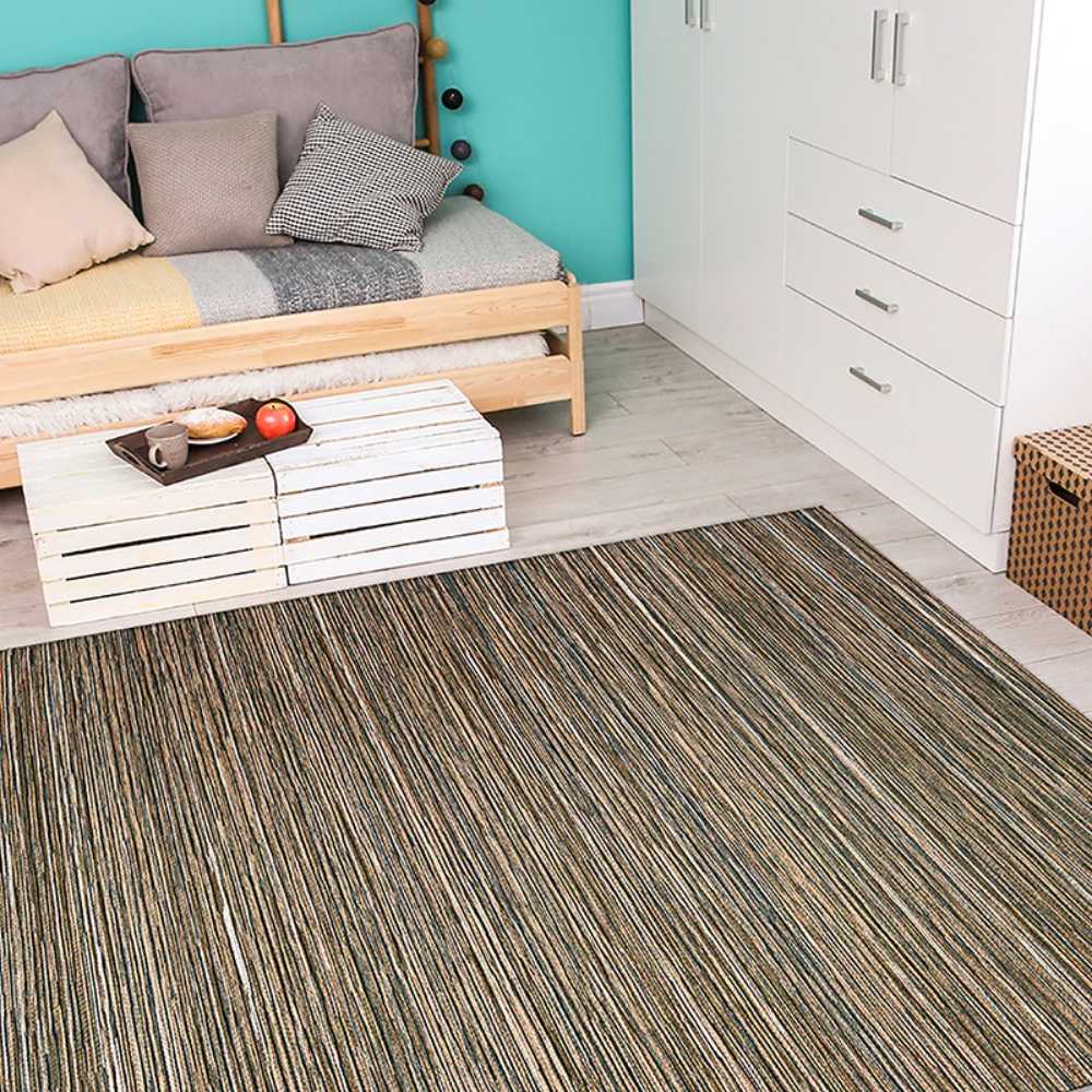 Couristan Cape Indoor/Outdoor Rug - Hinsdale/Brown-Ivory is neatly placed in a cozy bedroom with a wooden bed and colorful cushions