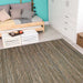 Couristan Cape Indoor/Outdoor Rug - Hinsdale/Brown-Ivory is neatly placed in a cozy bedroom with a wooden bed and colorful cushions