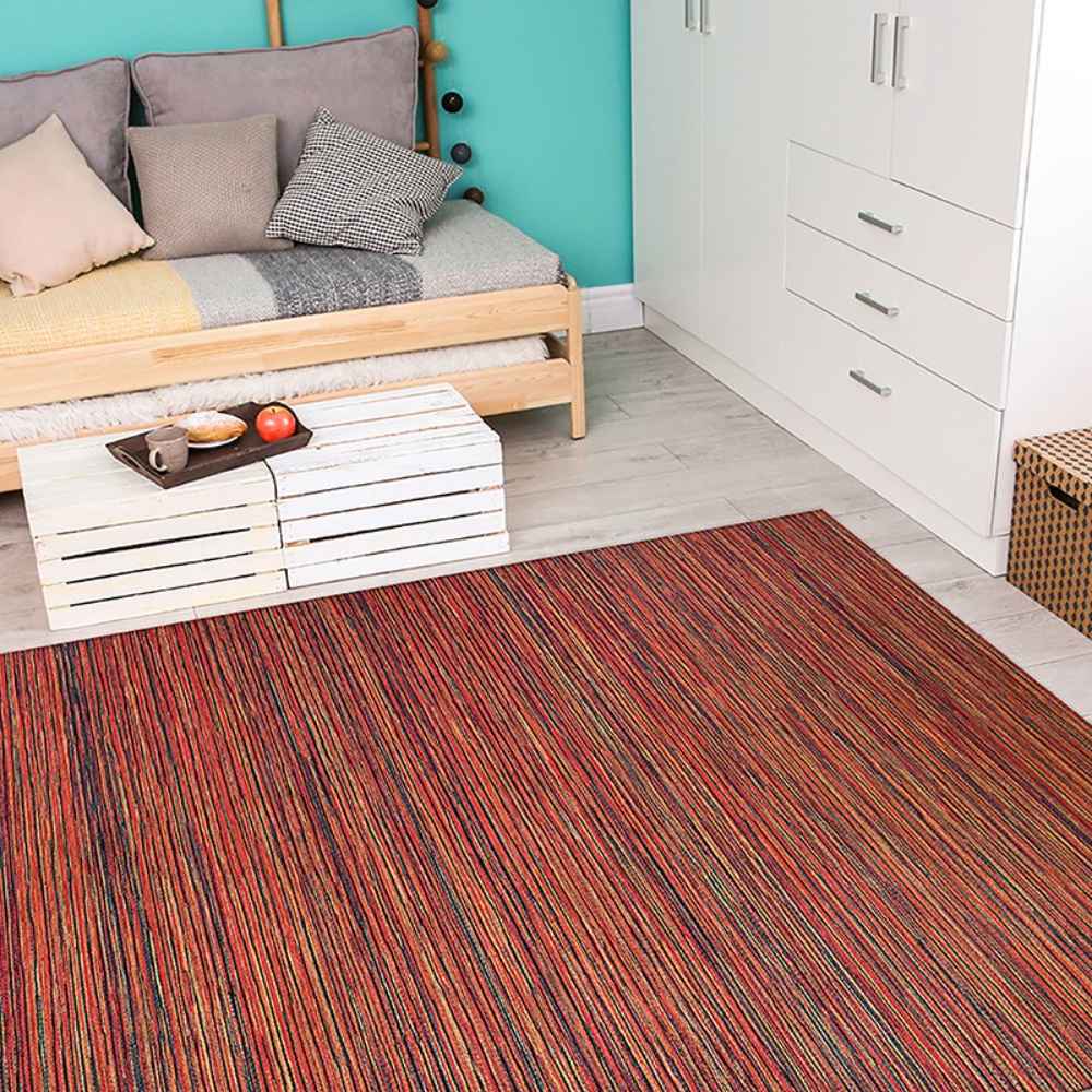 Couristan Cape Indoor/Outdoor Rug - Hinsdale/Crimson-Multi is laid out in a cozy, modern room with a wooden daybed and white furniture