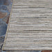 Couristan Cape Indoor/Outdoor Rug - Hinsdale/Light Brown-Silver lies flat over a stone patio
