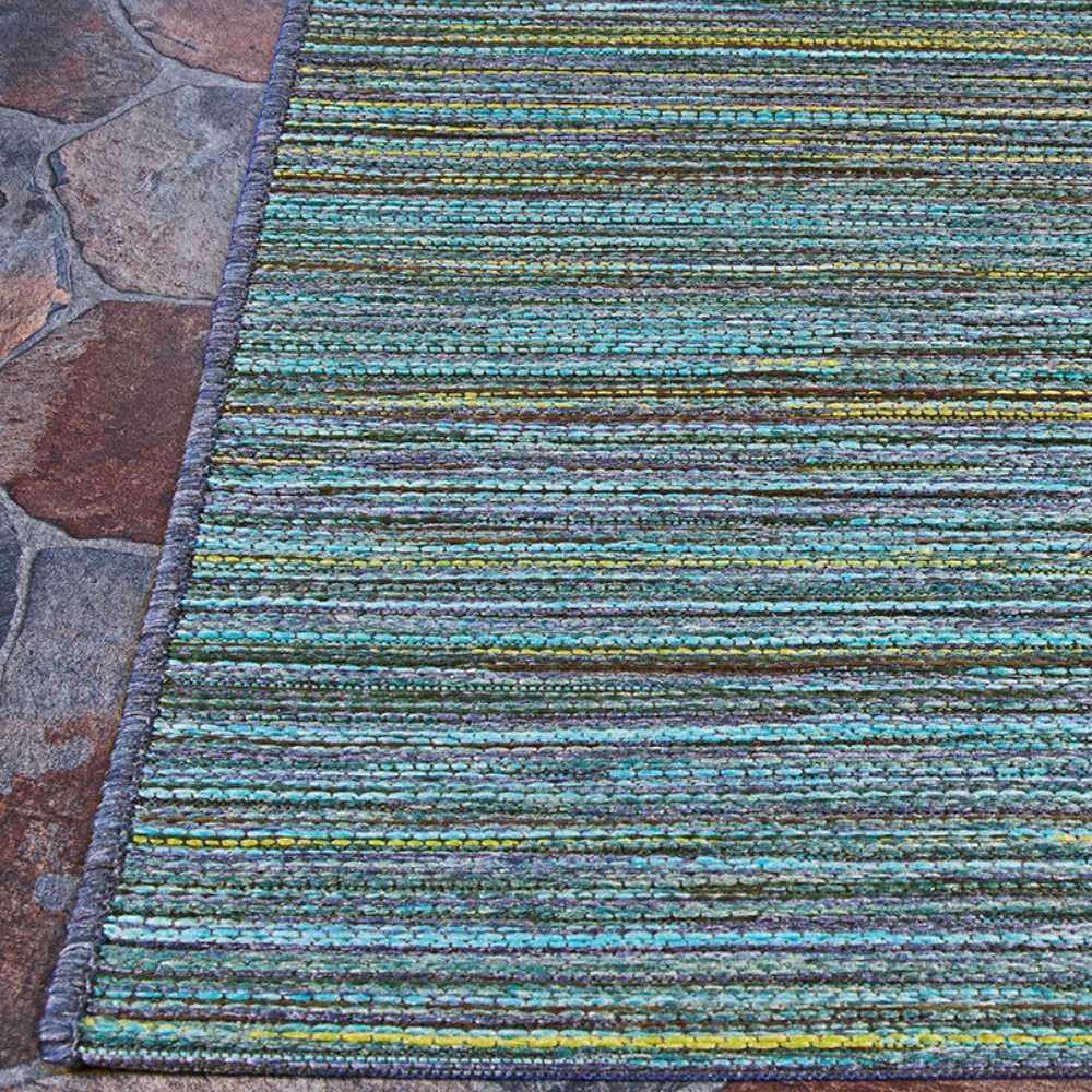 Couristan Cape Indoor/Outdoor Rug - Hinsdale/Teal-Cobalt is shown on a stone patio
