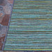 Couristan Cape Indoor/Outdoor Rug - Hinsdale/Teal-Cobalt is shown on a stone patio