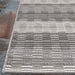 Couristan Cape Indoor/Outdoor Rug - Torrent/Sky Blue-Grey rests partially over a rustic tile floor