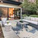 Couristan Castille Indoor/Outdoor Rug - Canvas/Orion adds style under a coffee table in a sleek outdoor patio setup next to a sliding glass door