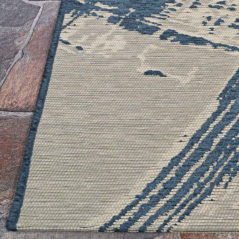 Couristan Castille Indoor/Outdoor Rug - Canvas/Orion sits on stone tiles