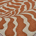 Couristan Castille Indoor/Outdoor Rug - Fiore/Terra-Cotta displays a sweeping leaf-like pattern in terracotta and beige across a flat surface