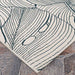 Couristan Castille Indoor/Outdoor Rug - Palma/Petrol corner is displayed on a stone floor