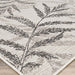 Couristan Charm Indoor/Outdoor Rug - Kimberly/Naturals shows detailed leaves in soft blacks and browns, woven into a light neutral background