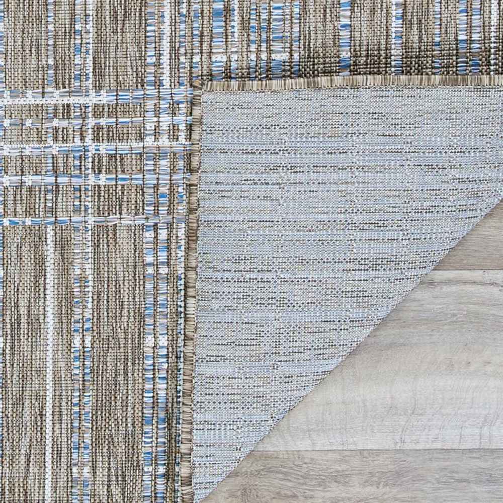 Couristan Charm Indoor/Outdoor Rug - Ohe/Sand-Ivory is flipped at the corner to display the non-slip backing and clean finish