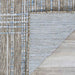 Couristan Charm Indoor/Outdoor Rug - Ohe/Sand-Ivory is flipped at the corner to display the non-slip backing and clean finish