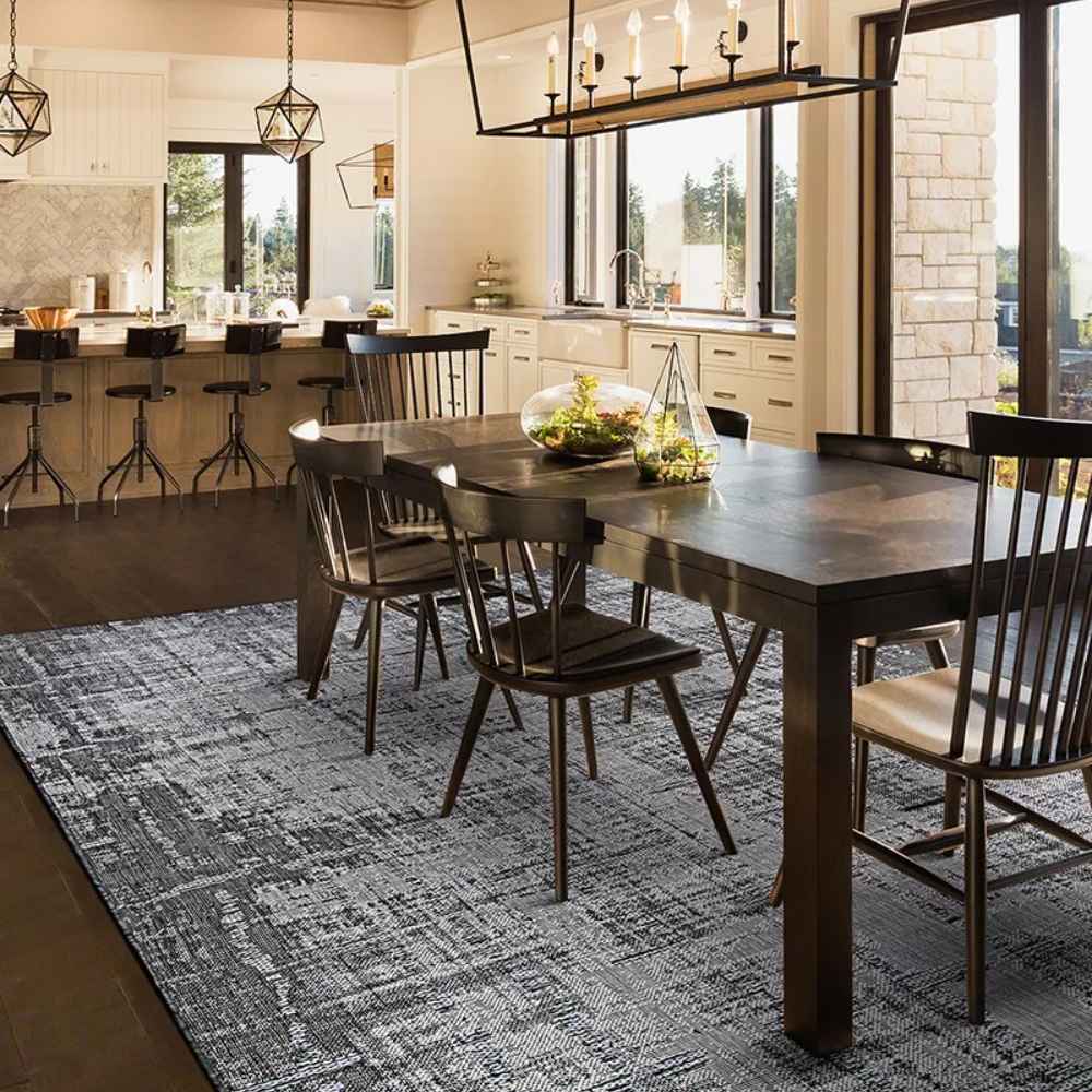 Couristan Charm Indoor/Outdoor Rug - Tiverton/Anthracite-Light Grey is styled under a dining table in a modern kitchen with natural lighting