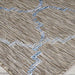 Couristan Charm Indoor/Outdoor Rug - Tiverton/Sand-Ivory features a close-up of its textured weave with a geometric pattern in blue and ivory on a sandy background