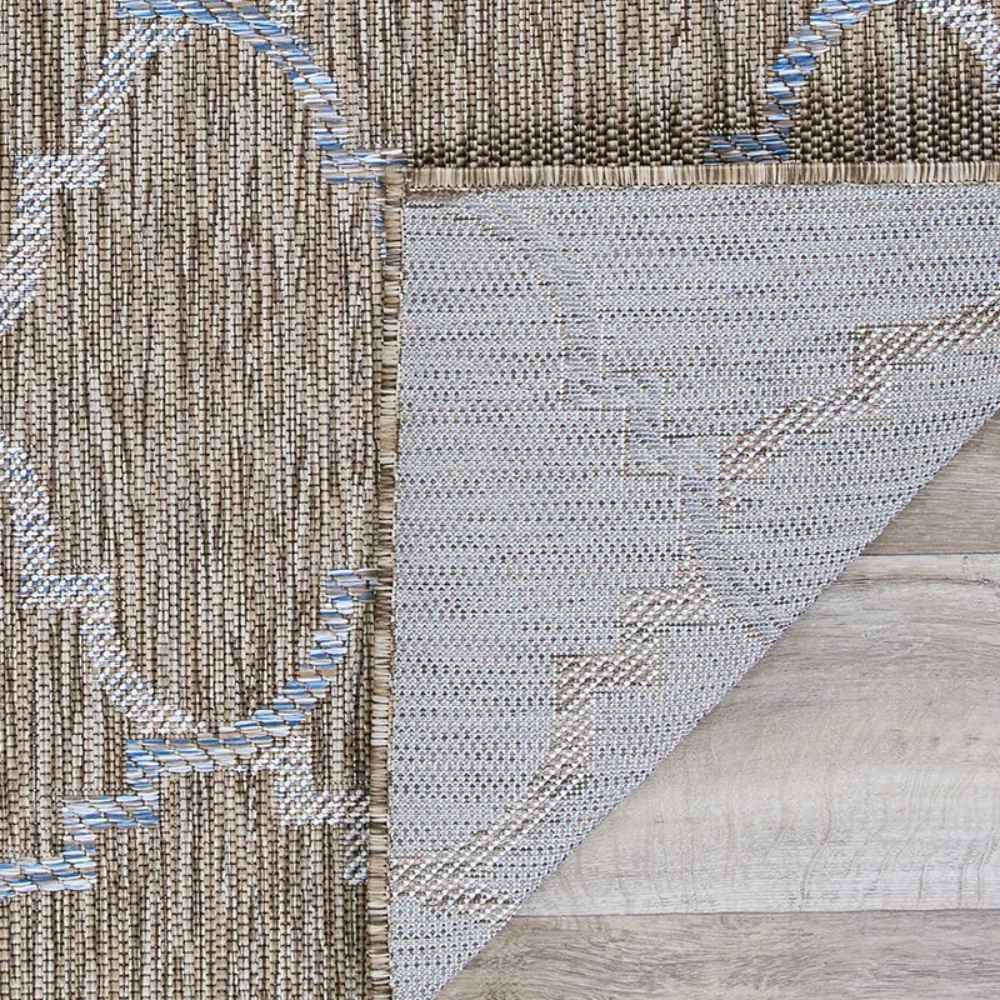 Couristan Charm Indoor/Outdoor Rug - Tiverton/Sand-Ivory is flipped over to show its durable backside and clean edge detailing