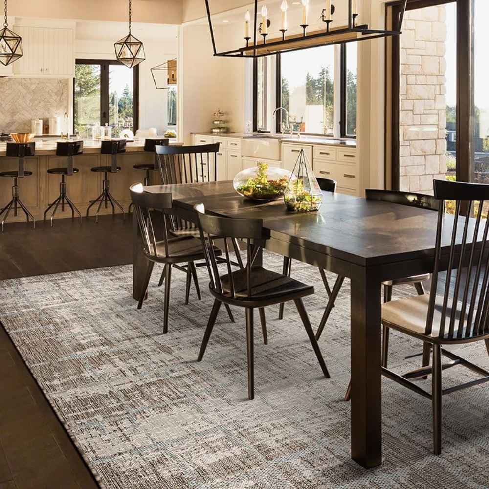 Couristan Charm Indoor/Outdoor Rug - Tiverton/Sand-Ivory is shown in a modern dining room, grounding the space with its neutral pattern and elegant texture