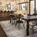 Couristan Charm Indoor/Outdoor Rug - Tiverton/Sand-Ivory is shown in a modern dining room, grounding the space with its neutral pattern and elegant texture