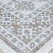 Couristan Charm Indoor/Outdoor Rug - Woodburn/Ivory-Sand is folded to reveal the corner’s layered patterns and contrasting motifs