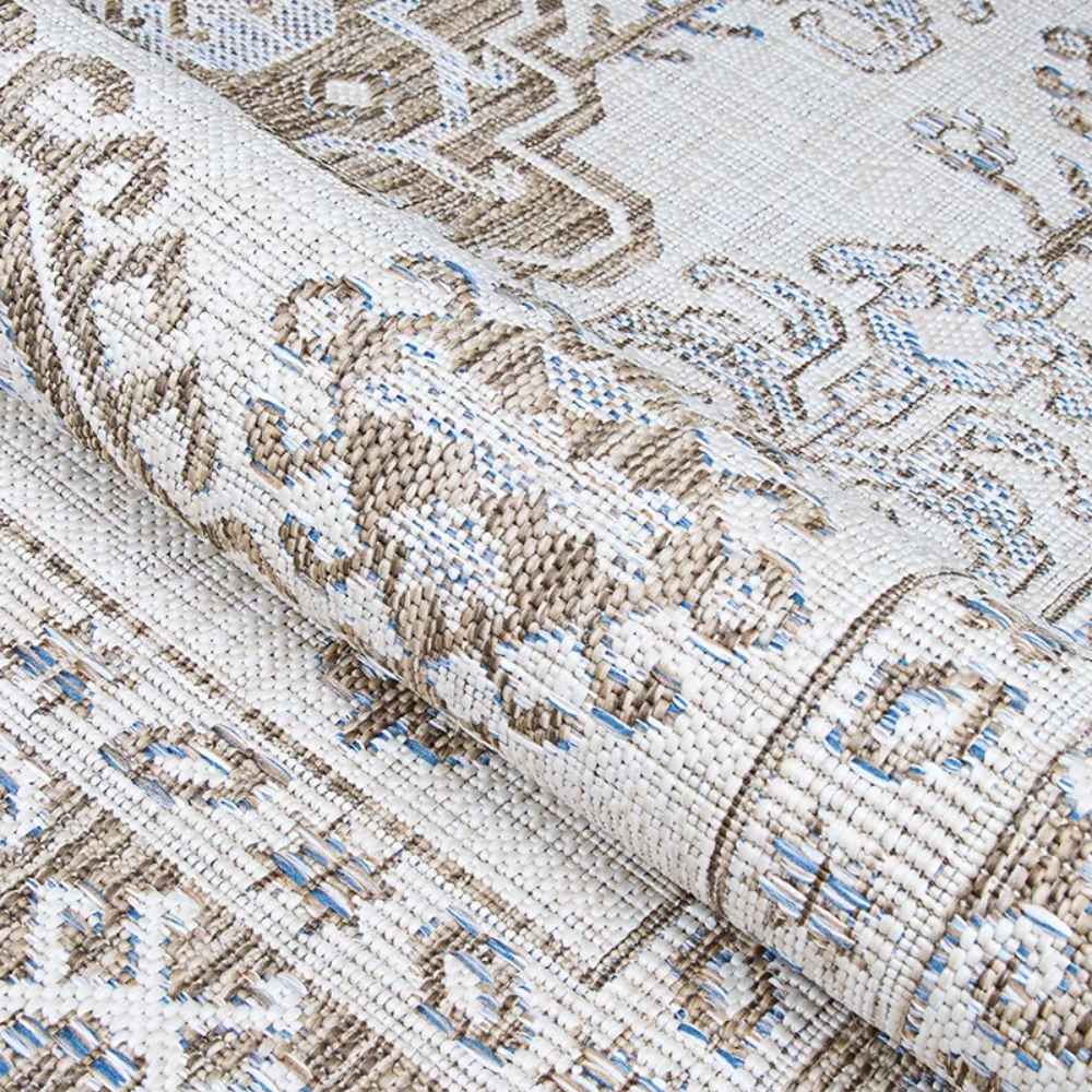 Couristan Charm Indoor/Outdoor Rug - Woodburn/Ivory-Sand is shown partially rolled