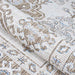 Couristan Charm Indoor/Outdoor Rug - Woodburn/Ivory-Sand is shown partially rolled