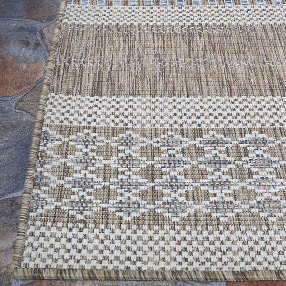 Couristan Charm Indoor/Outdoor Rug - Yukon/Twig lies flat on stone flooring