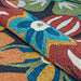 Couristan Covington Indoor/Outdoor Rug - Geranium/Navy-Multi is shown partially rolled