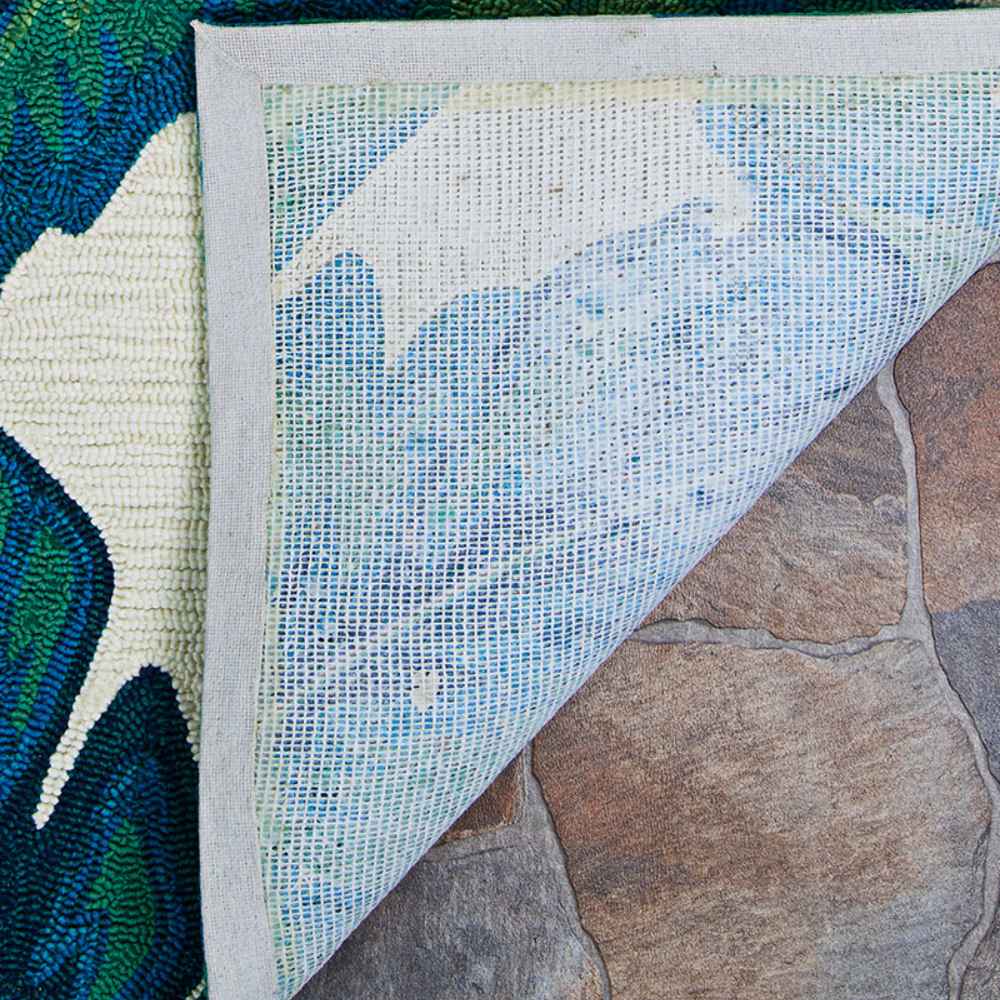 Couristan Covington Indoor/Outdoor Rug - Palm Leaves/Green is flipped at the corner to reveal its latex backing for indoor and outdoor durability