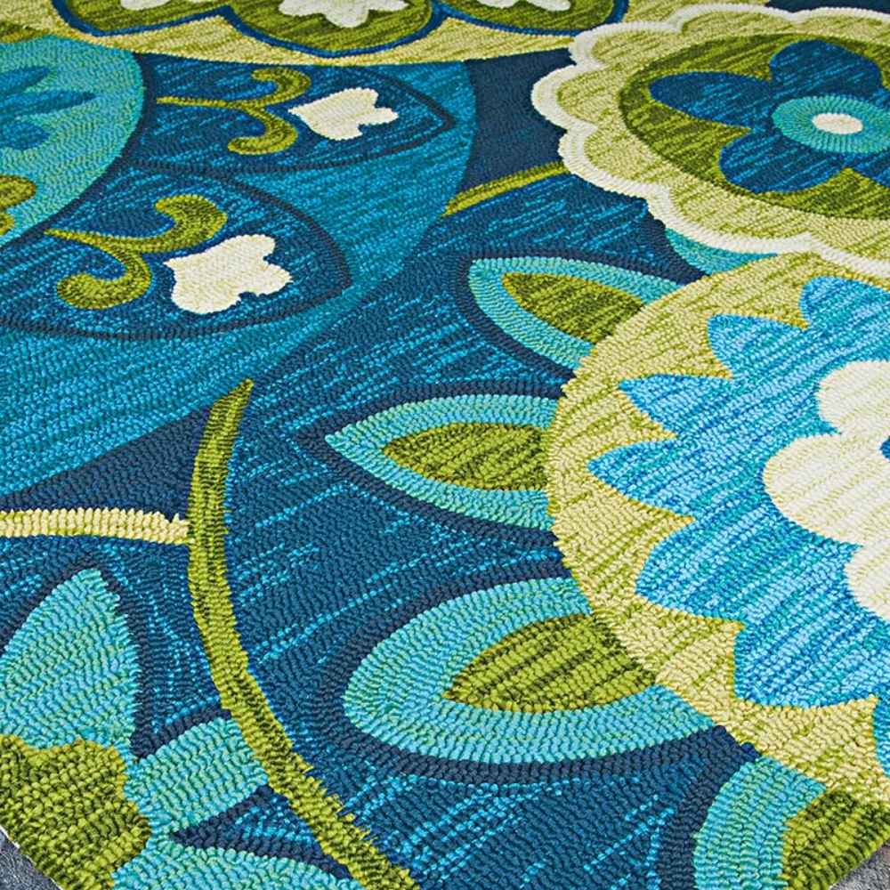 Couristan Covington Indoor/Outdoor Rug - Rip Tide/Ocean-Green displays a richly textured surface with swirling floral and leaf designs in shades of green, blue, and cream