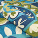 Couristan Covington Indoor/Outdoor Rug - Rip Tide/Ocean-Green is shown partially rolled, highlighting its flexibility and bold edge detailing