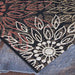 Couristan Dolce Indoor/Outdoor Rug - Amalfi/Multi lies on a stone surface, displaying detailed cream and rust floral patterns on a dark background