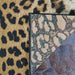 Couristan Dolce Indoor/Outdoor Rug - Amur Leopard/New Gold features a close-up of the rug's front and back corners