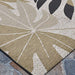 Couristan Dolce Indoor/Outdoor Rug - Aralia/Naturals-Cool Onyx features a large botanical pattern in beige, white, and black tones