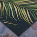 Couristan Dolce Indoor/Outdoor Rug - Bamboo Forest/Cool Onyx displays detailed tropical palm fronds in shades of green and yellow