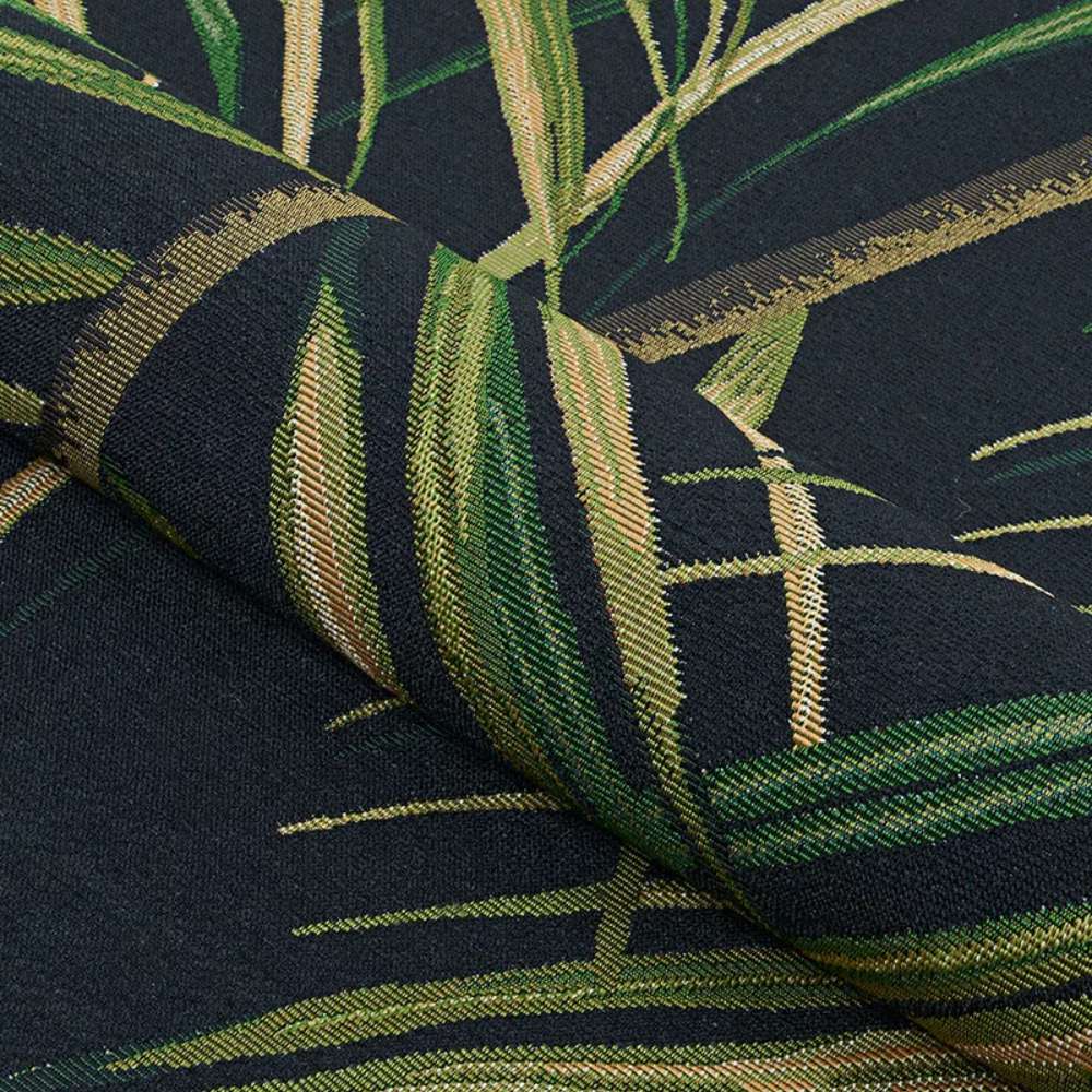 Couristan Dolce Indoor/Outdoor Rug - Bamboo Forest/Cool Onyx is shown partially rolled